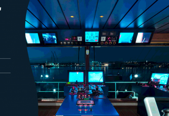 A ship's control room at night, illuminated by various electronic screens and monitors, with a view of the harbor outside the windows